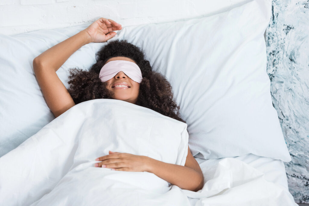 Woman with white, healthy teeth waking up refreshed after sleep